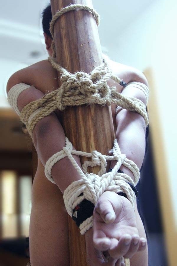 Bondage thumbs tied with rope